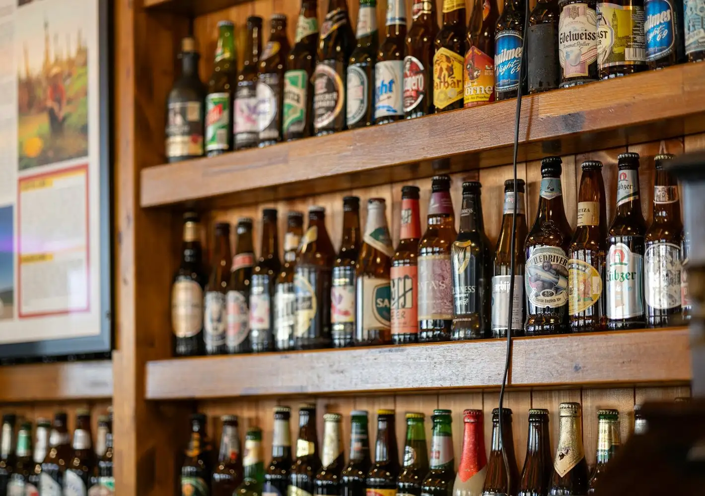 Shelves stocked with imported beer bottles