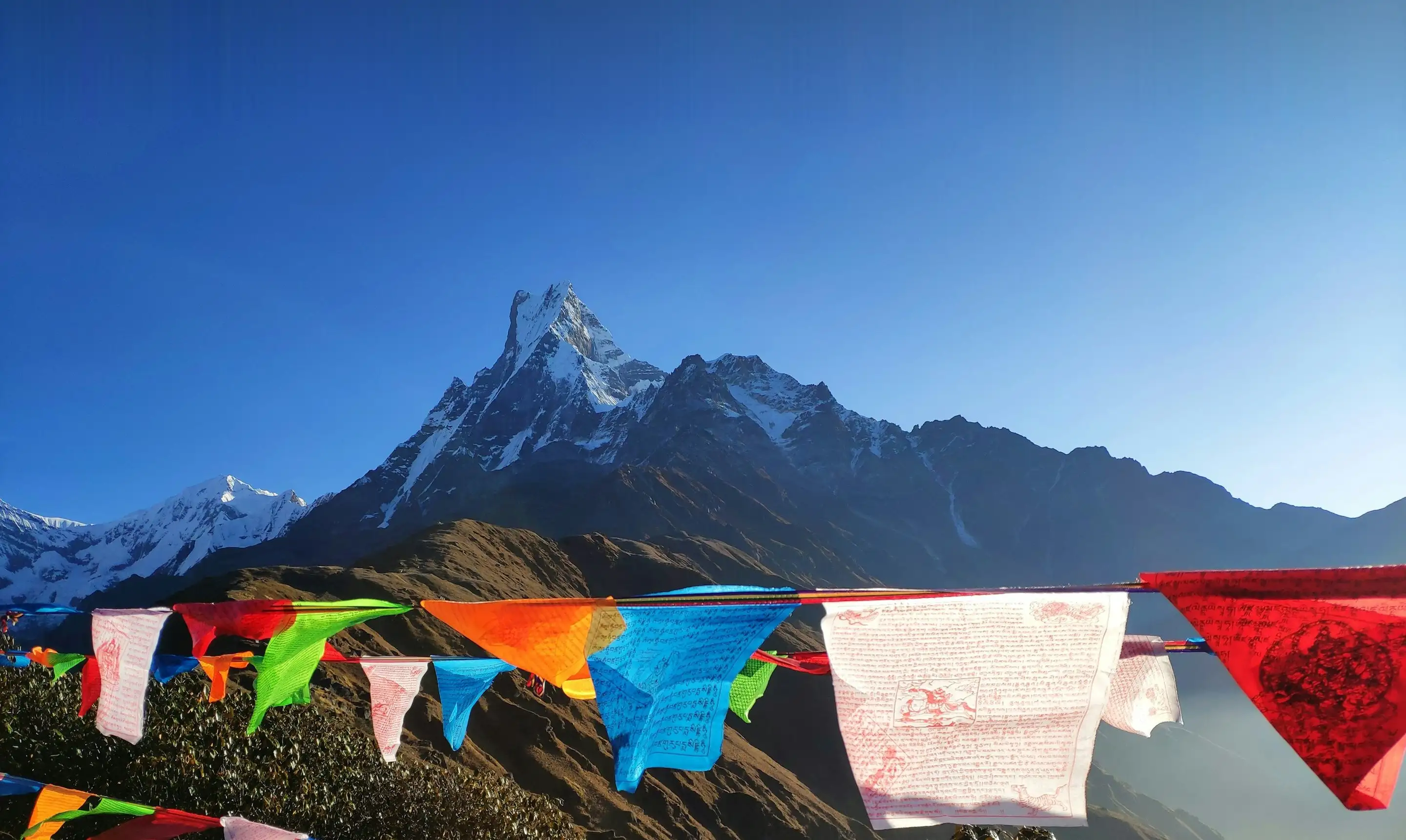 Machapuchare peak behind colourful prayer flags